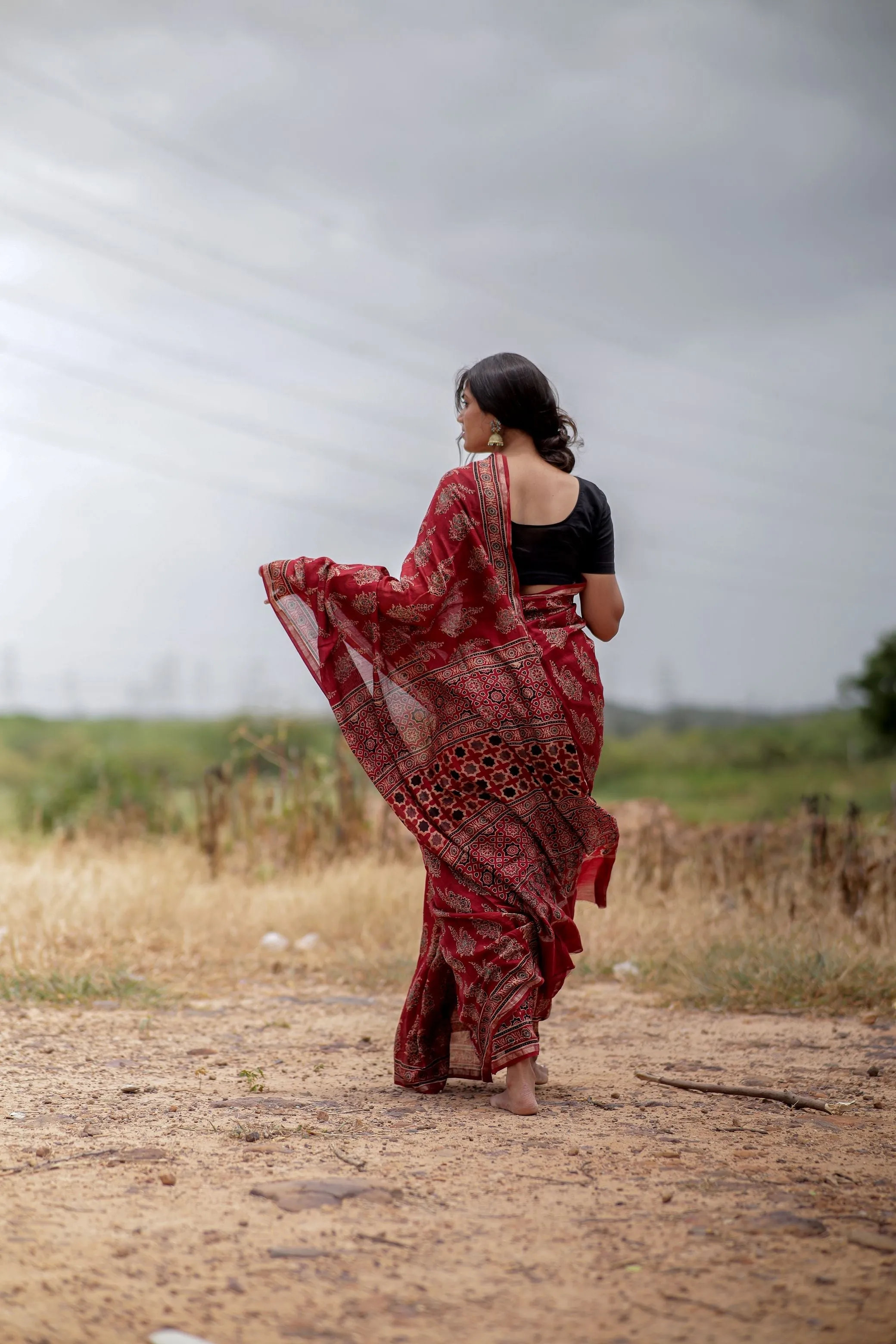A trsyt with Ajrakh -Jharokha -floral red chanderi ajrakh saree